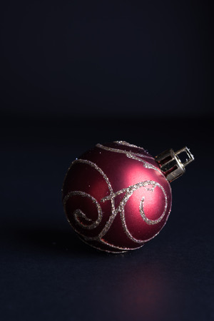 Red Christmas ball on dark backgroundの写真素材