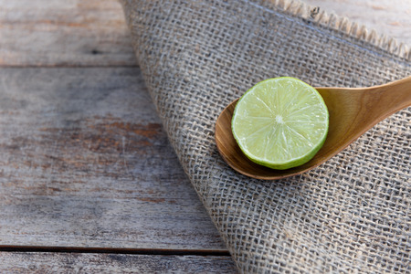 Slice of fresh limes on old wood table backgroundの写真素材
