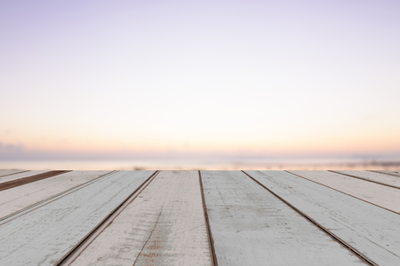 Vintage wood plank with beautiful seascape sunset backgroundの写真素材