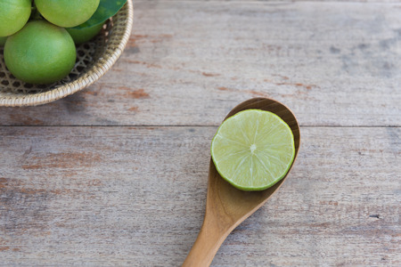 Slice of fresh limes on old wood table background