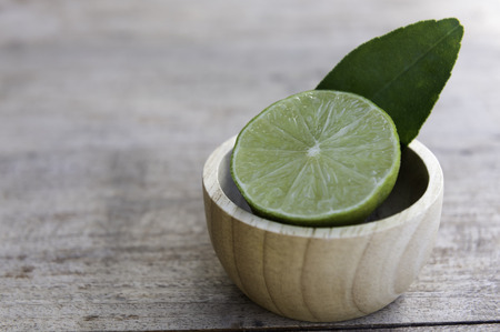 Fresh slice half  lime decoration in small wood bowlの写真素材
