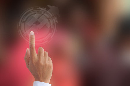 Business hand point on technology background  with blurred screenの写真素材