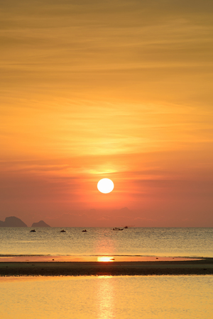 Big sunset with dramatic orange sea sky and cloud backgroundの写真素材