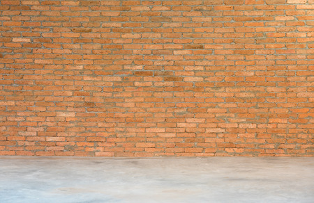 Old red brick wall and cement floor roomの写真素材