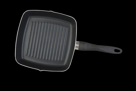 Frying pan with teflon coating isolated on black backgroundの写真素材
