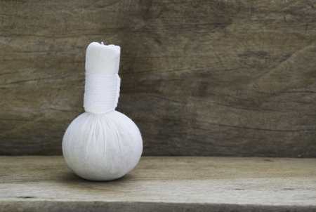 Herbal massage ball spa aromatherapy product on wooden backgroundの写真素材