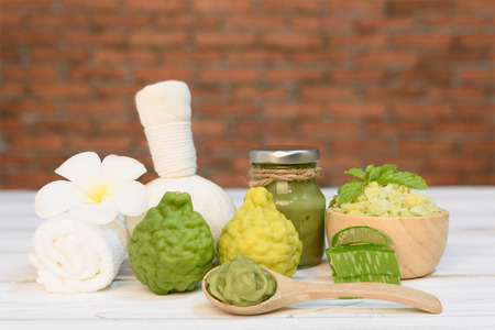 Spa aromatherapy and hair treatment with Karrif lime,aloe vera,sea salt,massage ball  on white wood table with red brick wall backgroundの写真素材