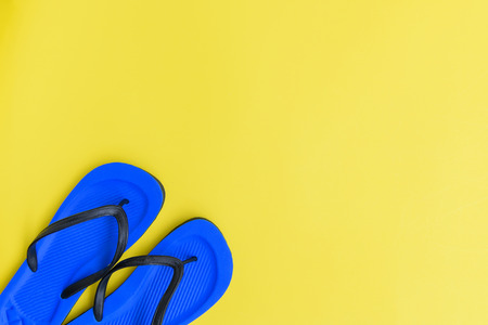 Flat lay,beach flip flops shoe on yellow background,top viewの写真素材