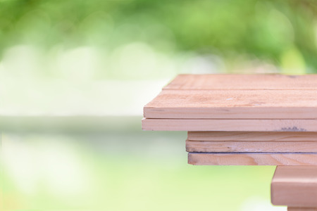 Wood top with space for products display and nature green background