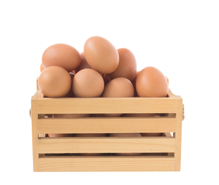 Brown eggs in wood basket isolated on white background with clipping pathの写真素材