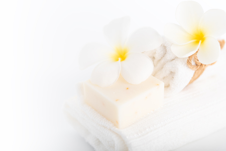 White towels,organic soap and Plumeria flower over white background,spa conceptの写真素材