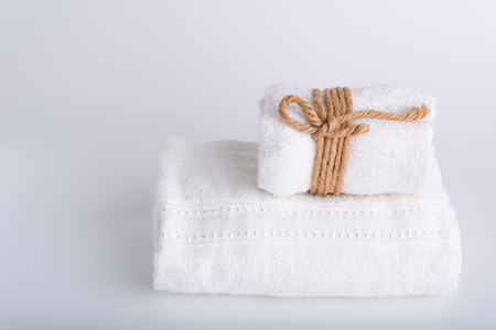 Rolled white towels spa object on white backgroundの写真素材