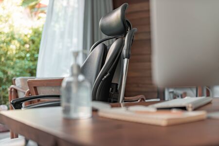 Work from home office gadget hygiene with computer and hand sanitizer protection from coronavirus outbreak or Covid-19の写真素材
