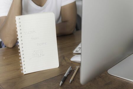 Woman work from home office  with computer on wooden table protection from coronavirus outbreak or Covid-19の写真素材