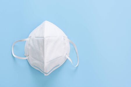 Surgical mask  for wearing germ protection from corona virus set on soft blue background,top viewの写真素材