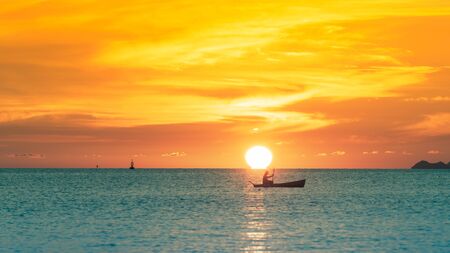 Omega sunset,Beautiful tropical beach summer sunset with golden lights background,Koh Samui Thailandの写真素材