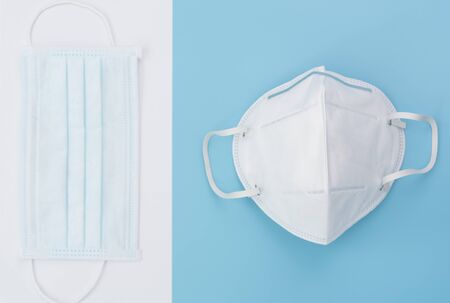 Surgical masks pack  on soft blue background,flat layの写真素材