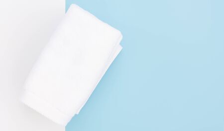 White towel on blue to tone background,top viewの写真素材