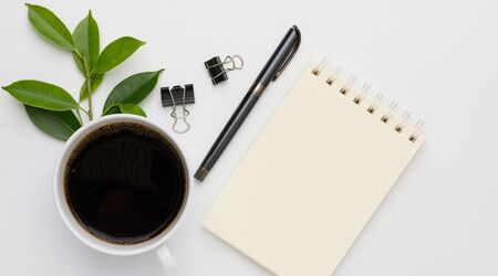 Work from home  with coffee cup, pen and notebook memo  on white background,flat layの写真素材