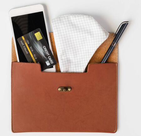 Women leather bag with necessary items cloth masks, credit card,pen and mobile phone for hygiene, cleaning and protect from Covid-19. Coronavirus,top viewの写真素材