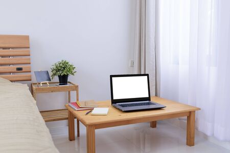 Workspace in white bedroom with notebook,memo pad and mobile phone at home,work from home conceptの写真素材