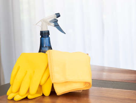 House cleaning products set on wooden table in living roomの写真素材