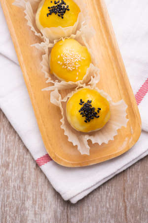 Chinese pastry bakery topping with black and white sesame  seeds on wooden tray ,top viewの写真素材
