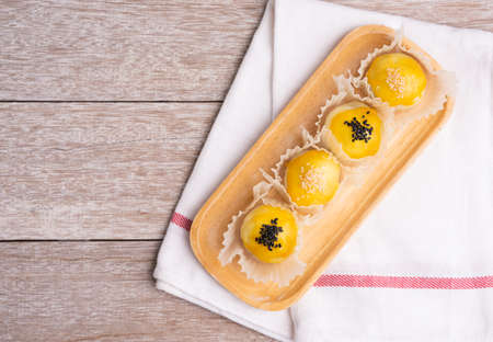 Chinese pastry bakery topping with black and white sesame  seeds on wooden tray ,top viewの写真素材