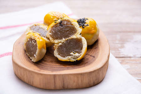 Chinese pastry bakery topping with black and white sesame seeds on wooden trayの写真素材