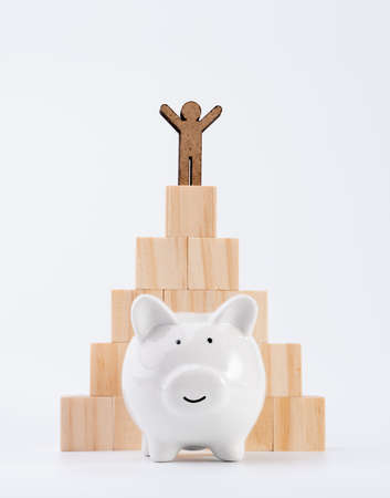 People model stand on wood cubes pyramid and piggy bank isolated on white background ,saving and invesment conceptの写真素材