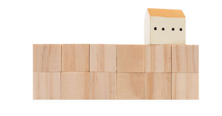 Wood cubes and house model isolated on white backgroundの写真素材