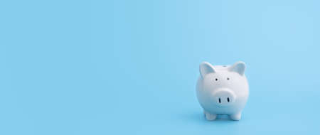 Piggy bank with copy space on blue background,front viewの写真素材