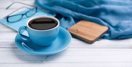Blue coffee cup   on white wooden  desk backgroundの写真素材