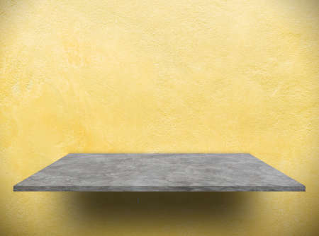 Perspective cement  shelf for products  with yellow concrete wall backgroundの写真素材