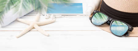 Summer background,straw hat,smart phone ,towel,ear phone and sunglasses with star fish on white wood table,clipping path on sun glasses  and mobile phoneの写真素材