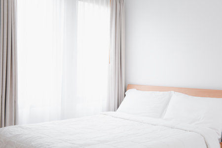Beautiful soft clean and cozy white bedroom interior with copy spaceの写真素材