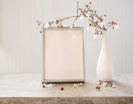 Blank mockup picture frame and dried flower in glass vase and beautiful Nodding Clerodendron flowers...