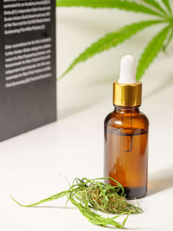 Medical CBD hemp oil extracts.Cannabis leaf flower and book on white background,Medical research conceptの写真素材