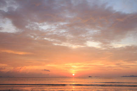 Beautiful tropical golden beach sunset with colourful sea skyの写真素材