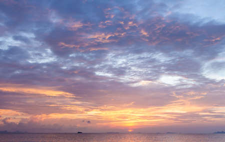 Beautiful tropical beach sunset with colourful sea skyの写真素材