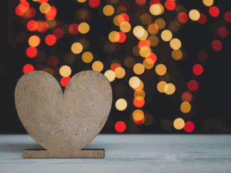 Heart shape on white wood table with colourful bokeh backgroundsの写真素材