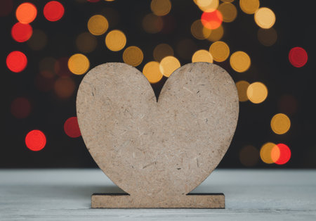 Heart shape on white wood table with colourful bokeh backgroundsの写真素材