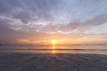 Beautiful tropical purple beach sunset with colourful sea skyの写真素材