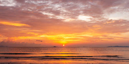 Beautiful tropical golden beach sunset with colourful sea skyの写真素材