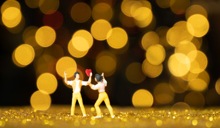 Miniature people man holding red heart for lover with light bokeh background,Valentines conceptの写真素材