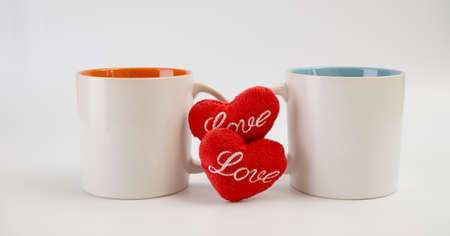 Cup of love,Two coffee cups with red heart icon on white backgroundの写真素材