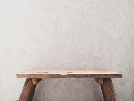 Teak wooden chair with space for products with cement wall backgroundの写真素材