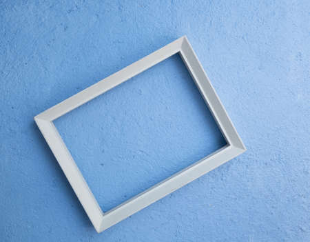 Vintage white picture rame mock up over blue cement  background,flat layの写真素材