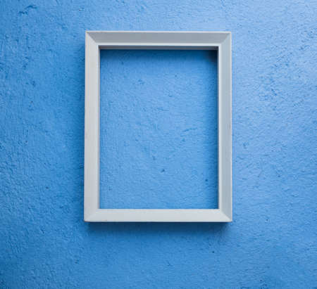 Vintage white picture rame mock up over blue cement  background,flat layの写真素材