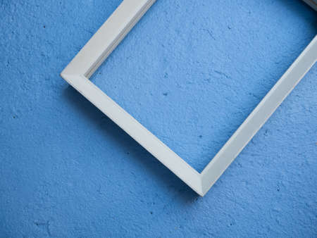 Vintage white picture rame mock up over blue cement  background,flat layの写真素材
